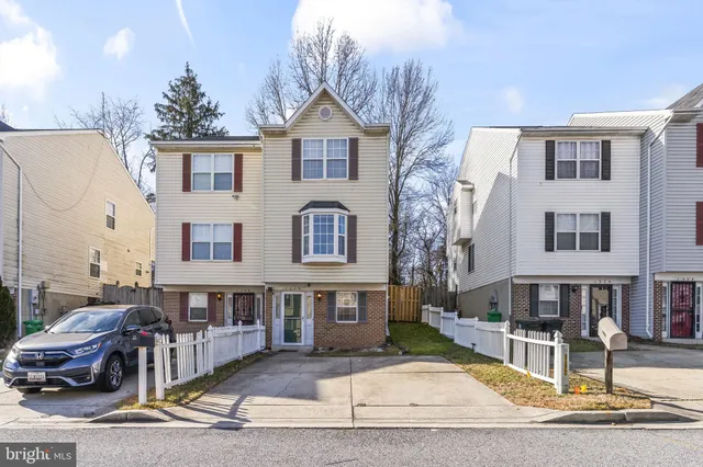 a front view of a residential apartment building with a yard