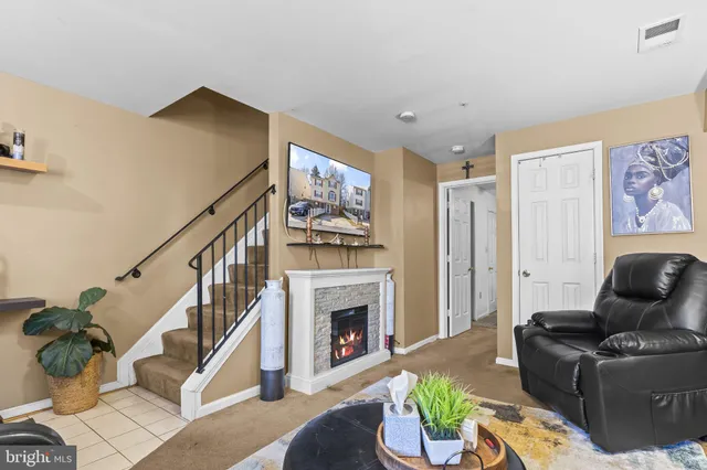 a living room with furniture and a fireplace