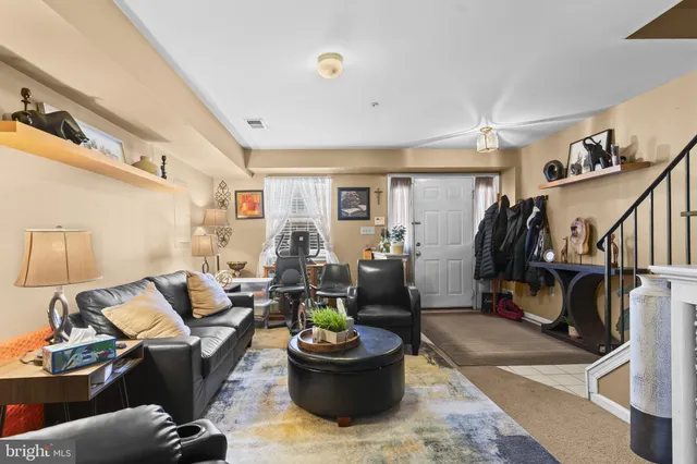 a living room with furniture and a gym cycle