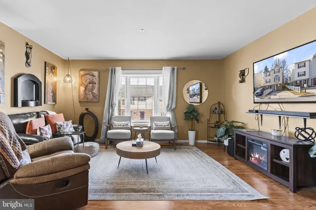 a living room with furniture a rug and a large window