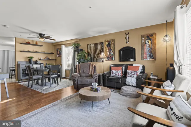 a living room with fireplace furniture and a large window