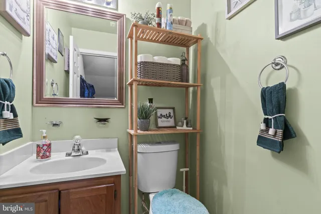 a bathroom with a toilet sink and mirror