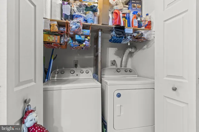 a view of storage and utility room with washer and dryer