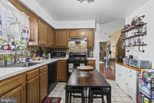 a kitchen with furniture and appliances
