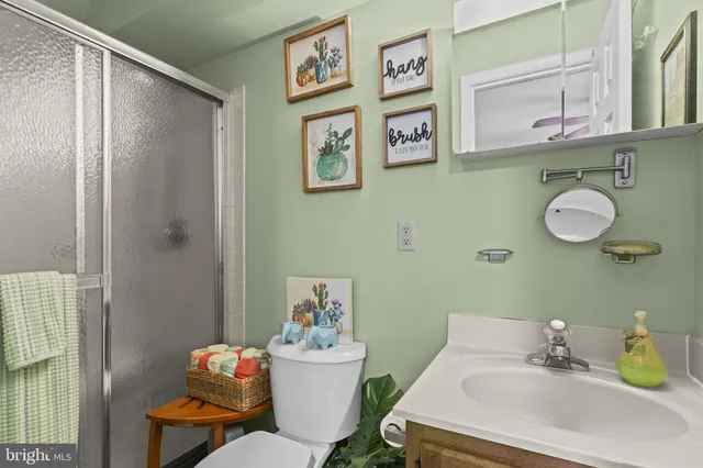 a bathroom with a sink mirror and toilet