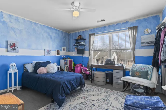 a bedroom with furniture and a large window