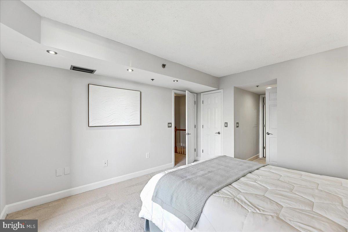 1276 North Wayne Street, Unit 418 Arlington, VA 22201 - Photo 22 of 38 a bedroom with a bed and a window