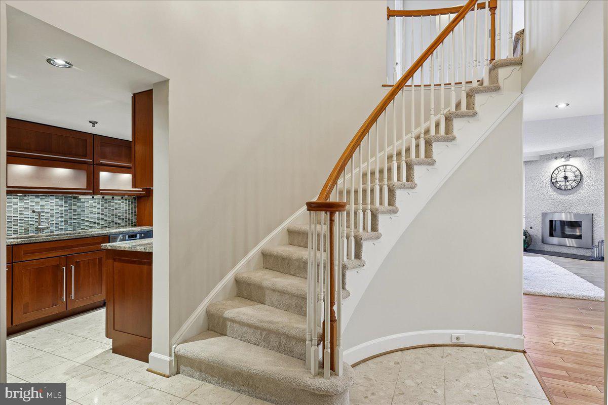 1276 North Wayne Street, Unit 418 Arlington, VA 22201 - Photo 3 of 38 a view of staircase with white walls and a floor to ceiling window