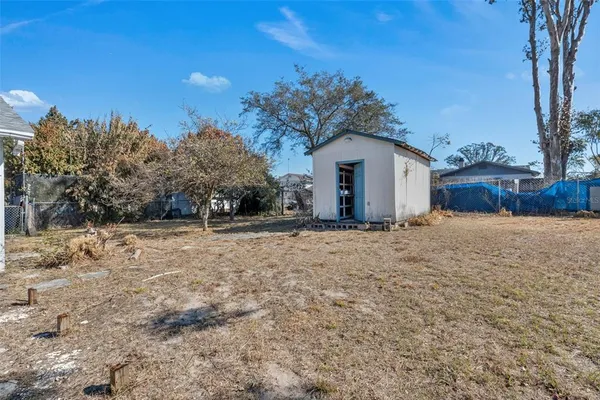 a white house that has a tree in front of it