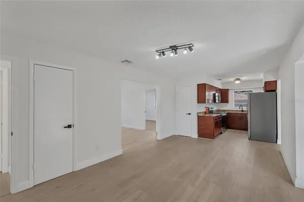 a view of a room with kitchen appliances and cabinets