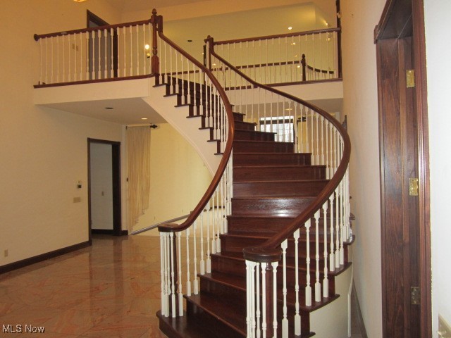 6999 Gates Road Gates Mills, OH 44040 - Photo 17 of 20 Stairway featuring a high ceiling and marble tiled floors