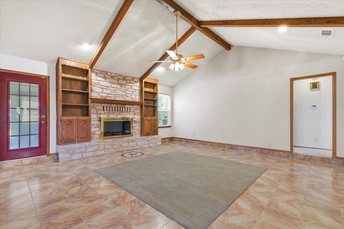 250 Hickory Drive Elgin, TX 78621 - Photo 8 of 37 a view of an empty room with fireplace and cabinet