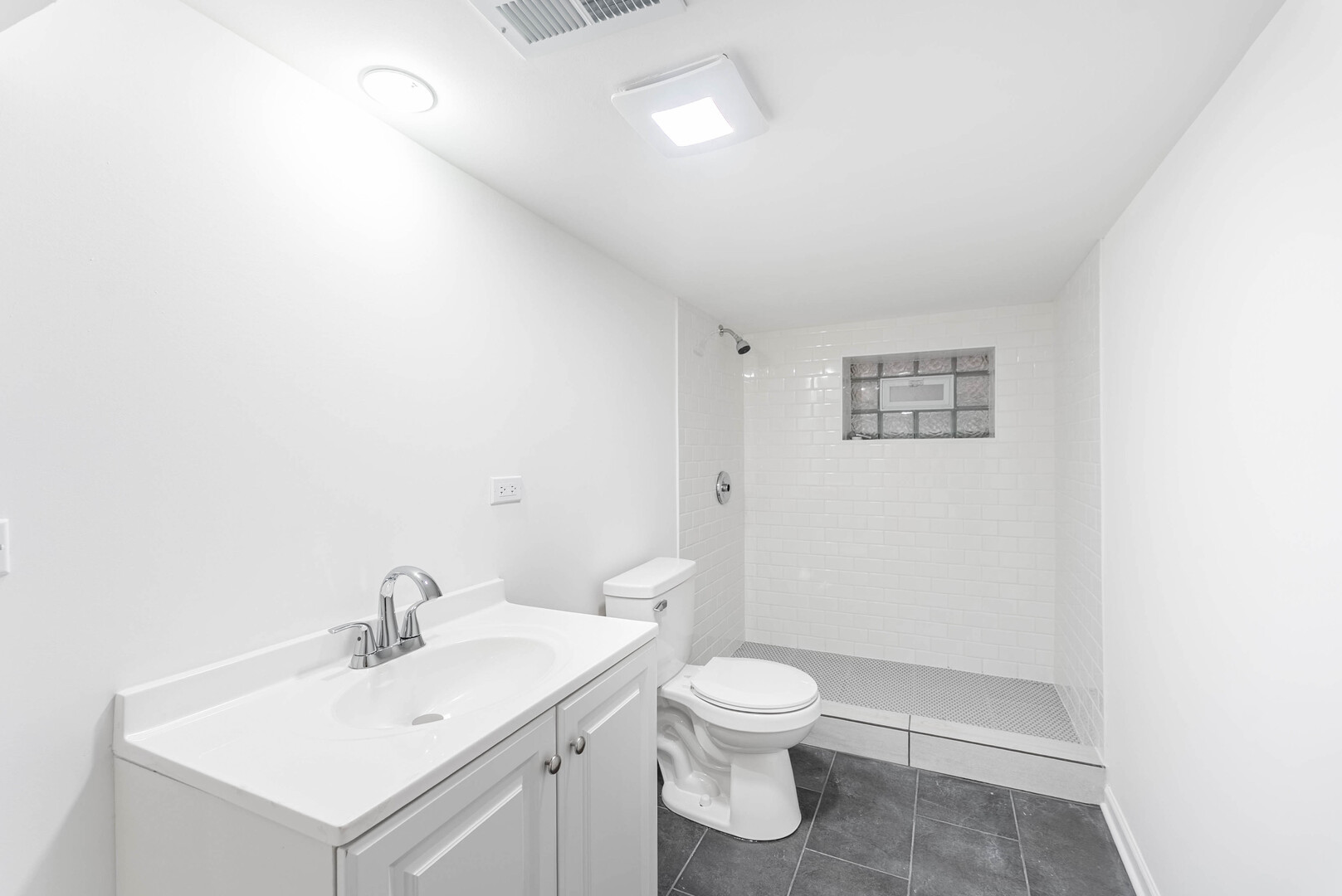 1719 North Merrimac Avenue Chicago, IL 60639 - Photo 33 of 35 a bathroom with a toilet sink and a mirror