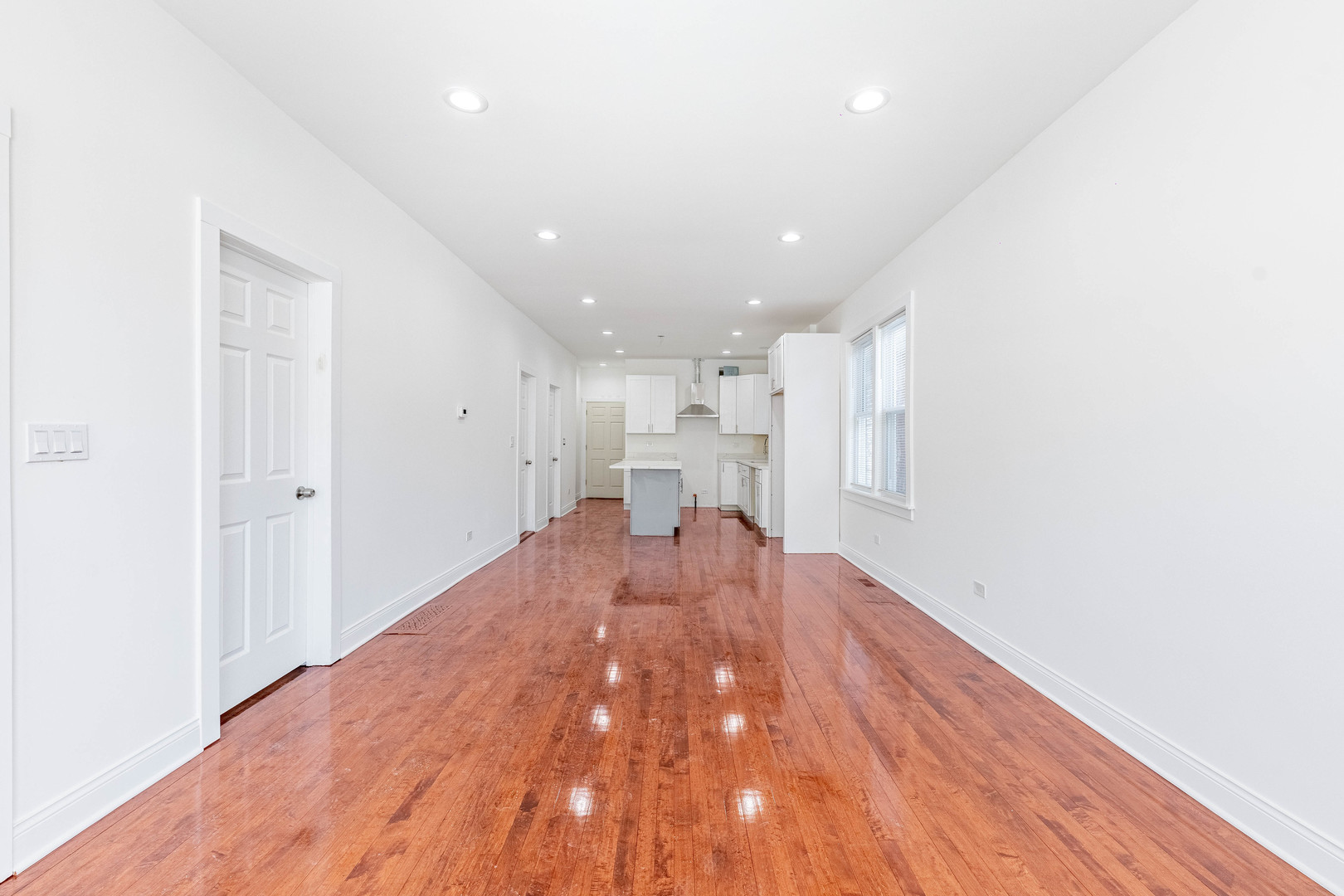 1719 North Merrimac Avenue Chicago, IL 60639 - Photo 4 of 35 a view of empty room with wooden floor