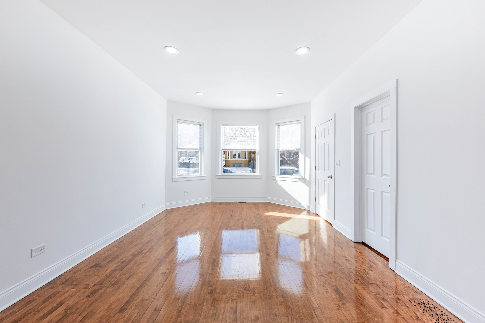 1719 North Merrimac Avenue Chicago, IL 60639 - Photo 5 of 35 wooden floor in an empty room with a window