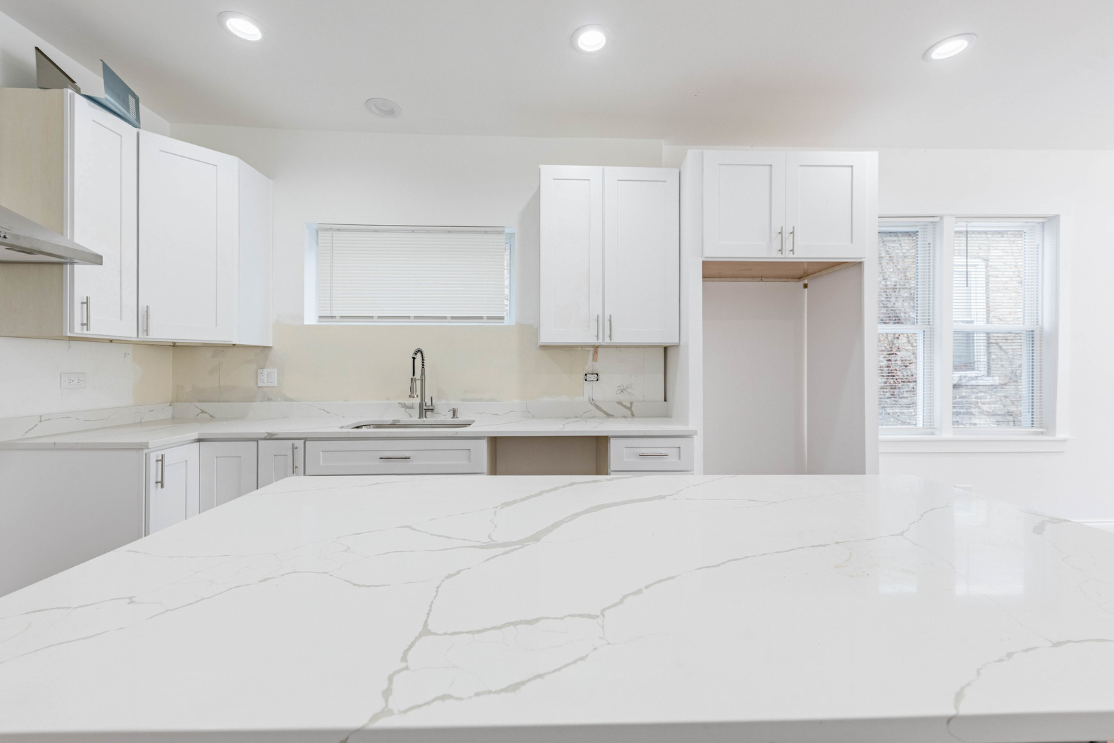 1719 North Merrimac Avenue Chicago, IL 60639 - Photo 8 of 35 a kitchen with granite countertop white cabinets and stainless steel appliances