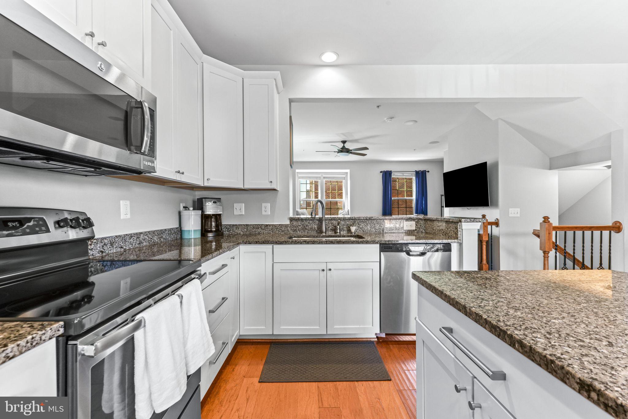 4648 Hudson Street Baltimore, MD 21224 - Photo 11 of 46 a kitchen with stainless steel appliances granite countertop a stove microwave and sink