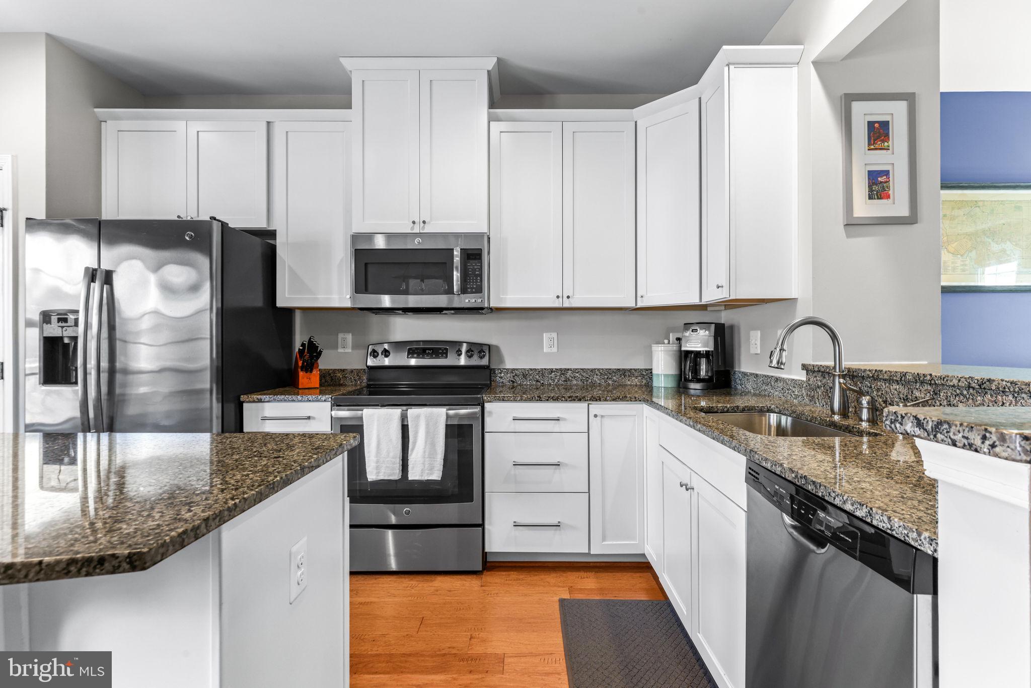 4648 Hudson Street Baltimore, MD 21224 - Photo 12 of 46 a kitchen with stainless steel appliances granite countertop a sink a stove and cabinets