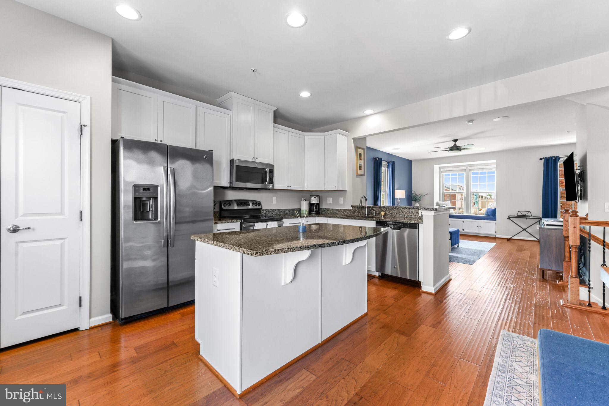 4648 Hudson Street Baltimore, MD 21224 - Photo 13 of 46 a kitchen with stainless steel appliances granite countertop a refrigerator and a stove top oven