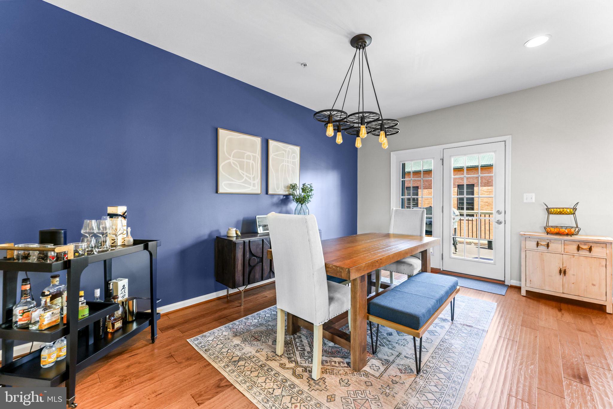 4648 Hudson Street Baltimore, MD 21224 - Photo 16 of 46 a dining room with furniture and chandelier