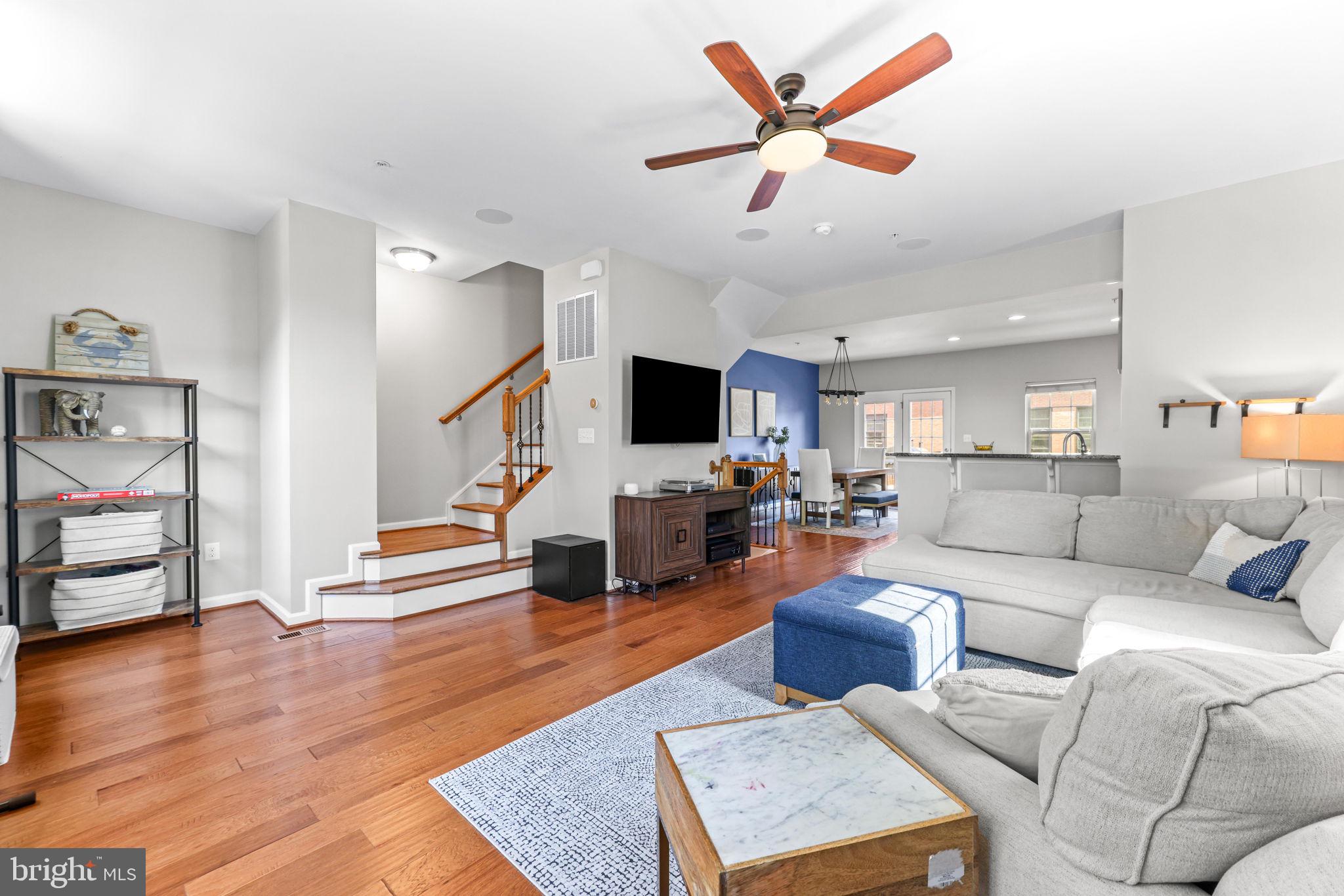 4648 Hudson Street Baltimore, MD 21224 - Photo 21 of 46 a living room with furniture kitchen view and a wooden floor