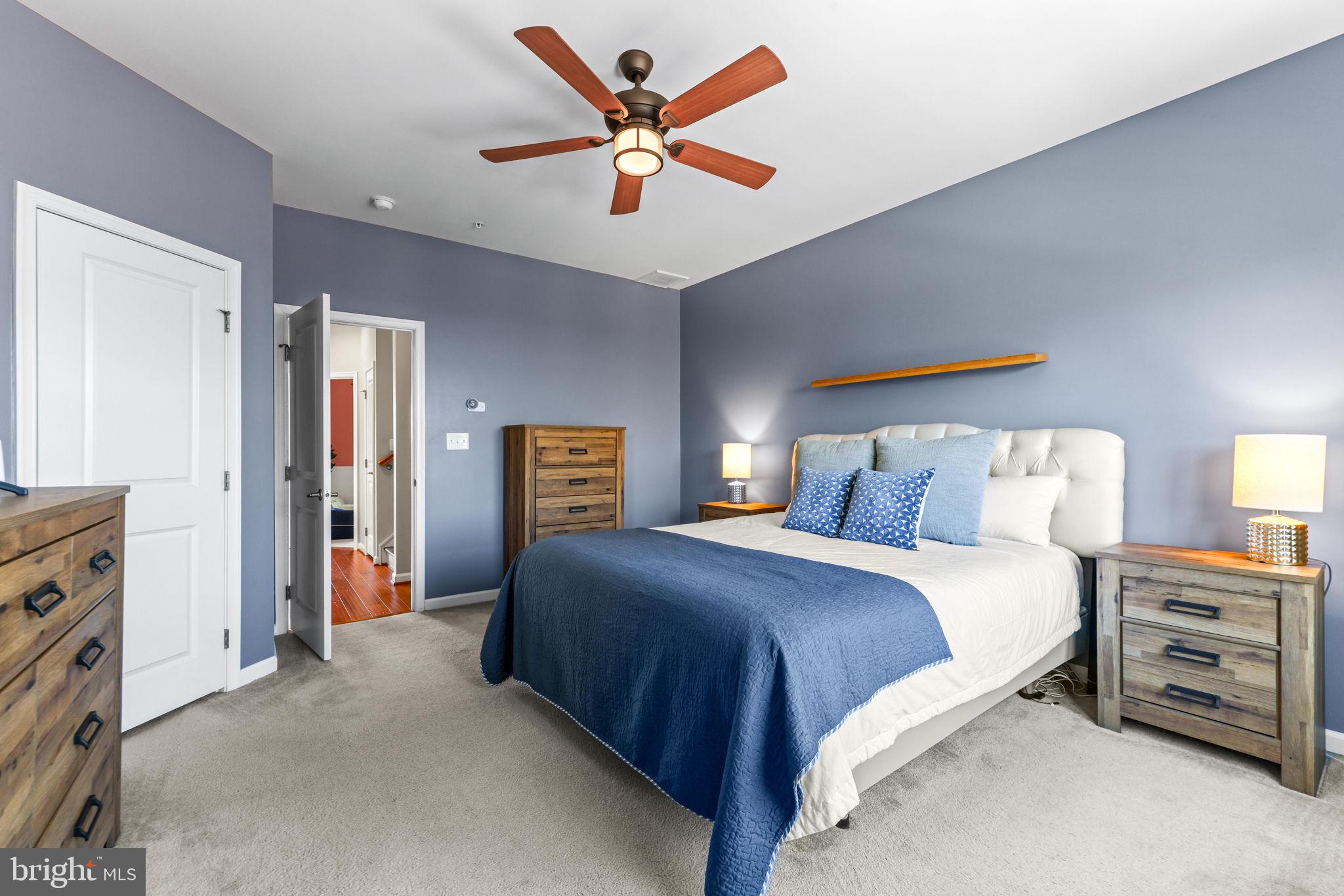 4648 Hudson Street Baltimore, MD 21224 - Photo 26 of 46 a bedroom with a bed and a chandelier