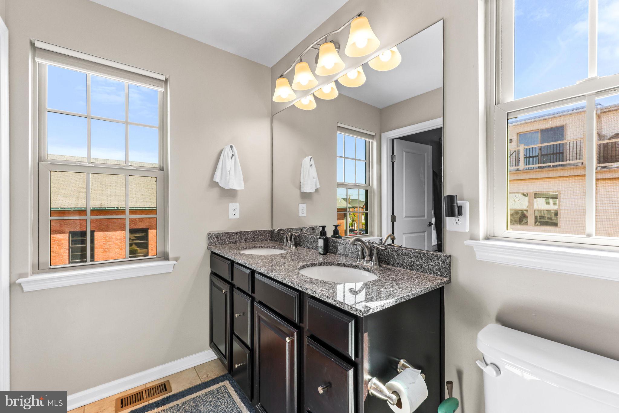 4648 Hudson Street Baltimore, MD 21224 - Photo 29 of 46 a bathroom with a sink and a mirror