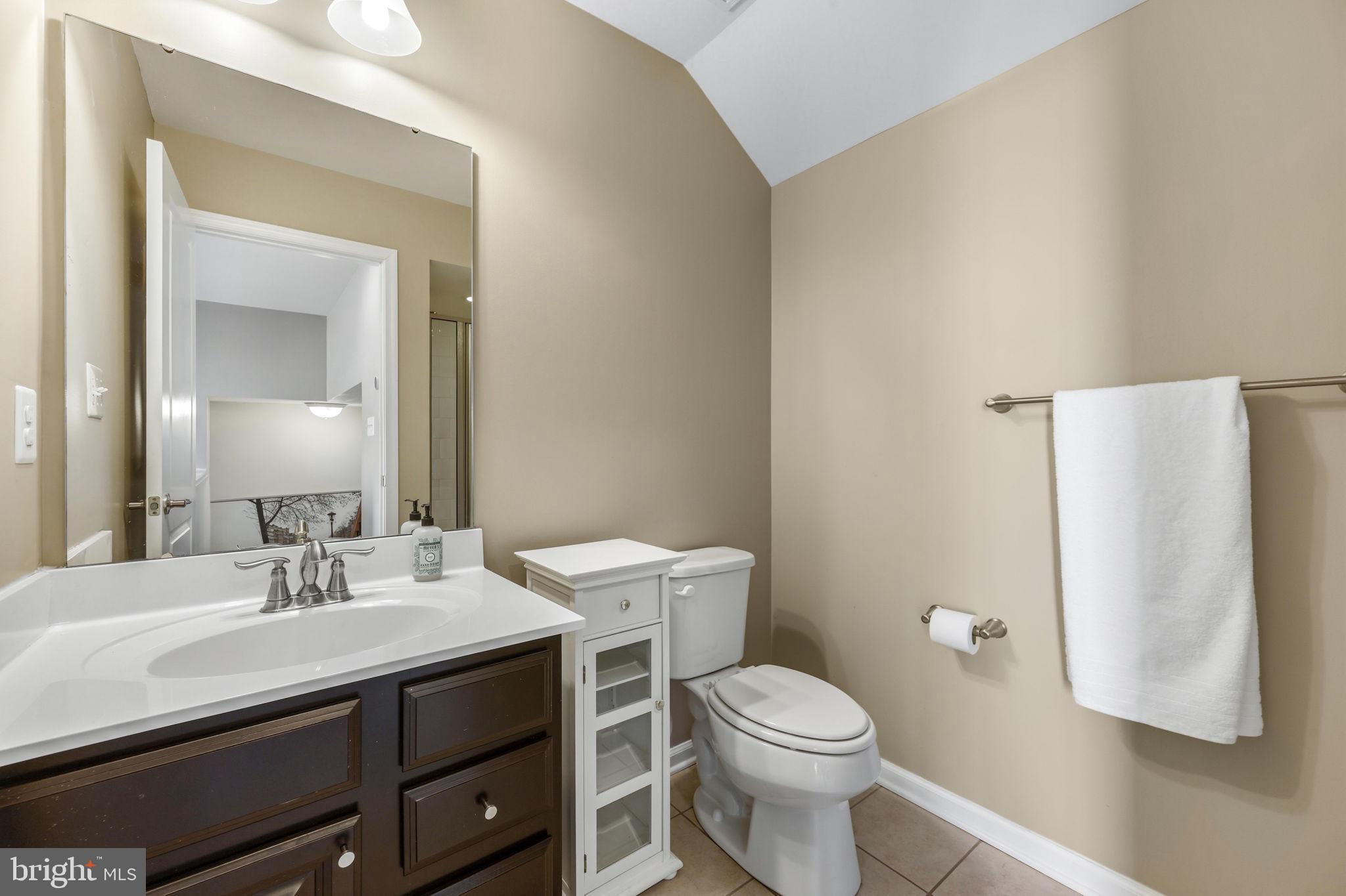 4648 Hudson Street Baltimore, MD 21224 - Photo 42 of 46 a bathroom with a sink toilet and mirror
