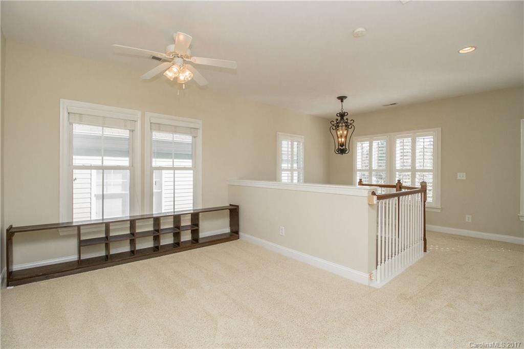 874 Promenade Walk, Unit 680 Fort Mill, SC 29708 - Photo 11 of 21 an empty room with windows and cabinet