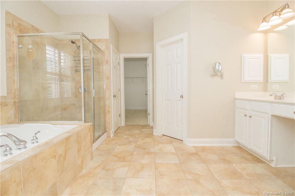 874 Promenade Walk, Unit 680 Fort Mill, SC 29708 - Photo 13 of 21 a bathroom with a bathtub sink and mirror