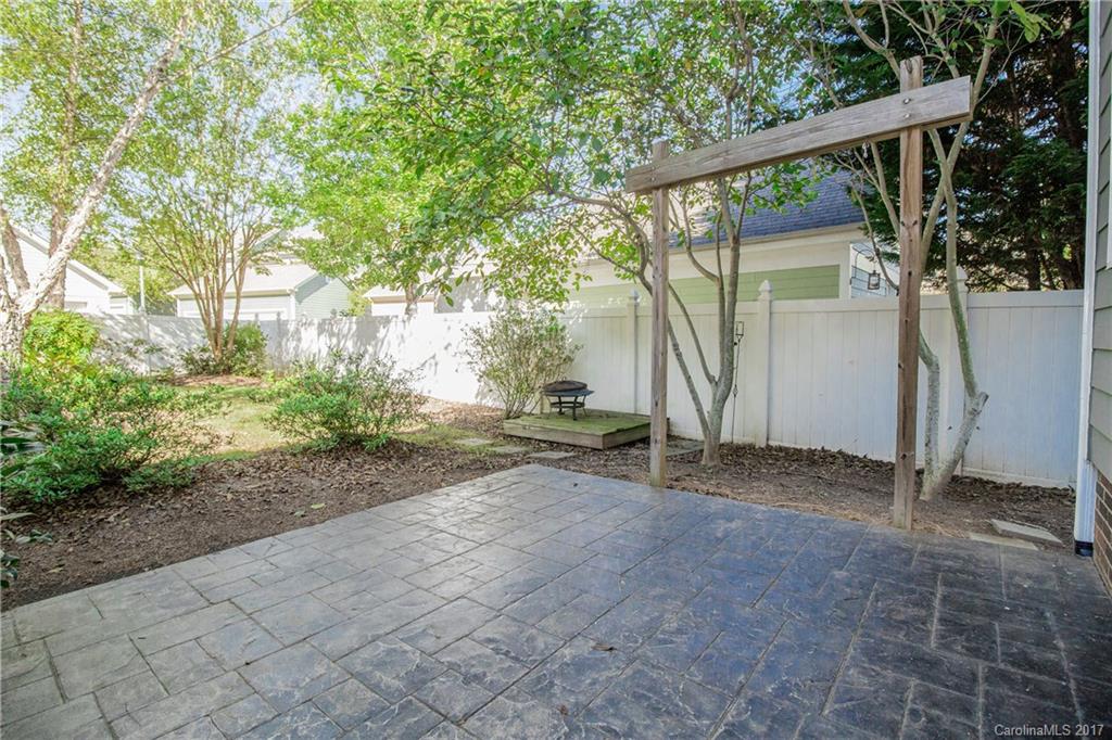874 Promenade Walk, Unit 680 Fort Mill, SC 29708 - Photo 18 of 21 a backyard of a house with plants and trees