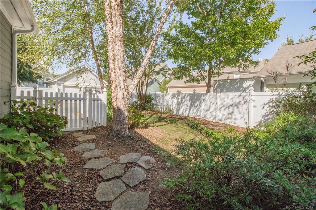 874 Promenade Walk, Unit 680 Fort Mill, SC 29708 - Photo 19 of 21 a view of a yard with plants and trees