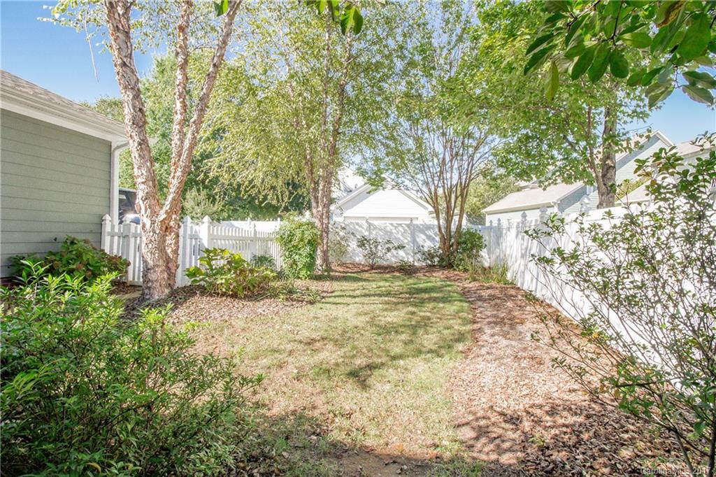 874 Promenade Walk, Unit 680 Fort Mill, SC 29708 - Photo 20 of 21 a view of a yard with plants and trees
