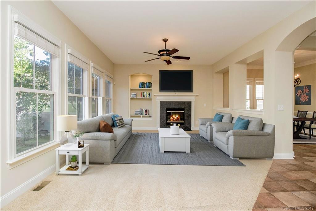 874 Promenade Walk, Unit 680 Fort Mill, SC 29708 - Photo 5 of 21 a living room with furniture a fireplace and a flat screen tv