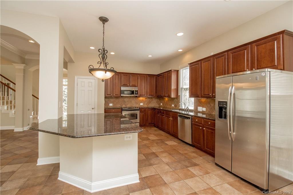 874 Promenade Walk, Unit 680 Fort Mill, SC 29708 - Photo 7 of 21 a kitchen with stainless steel appliances granite countertop a refrigerator a oven a sink a stove and a refrigerator