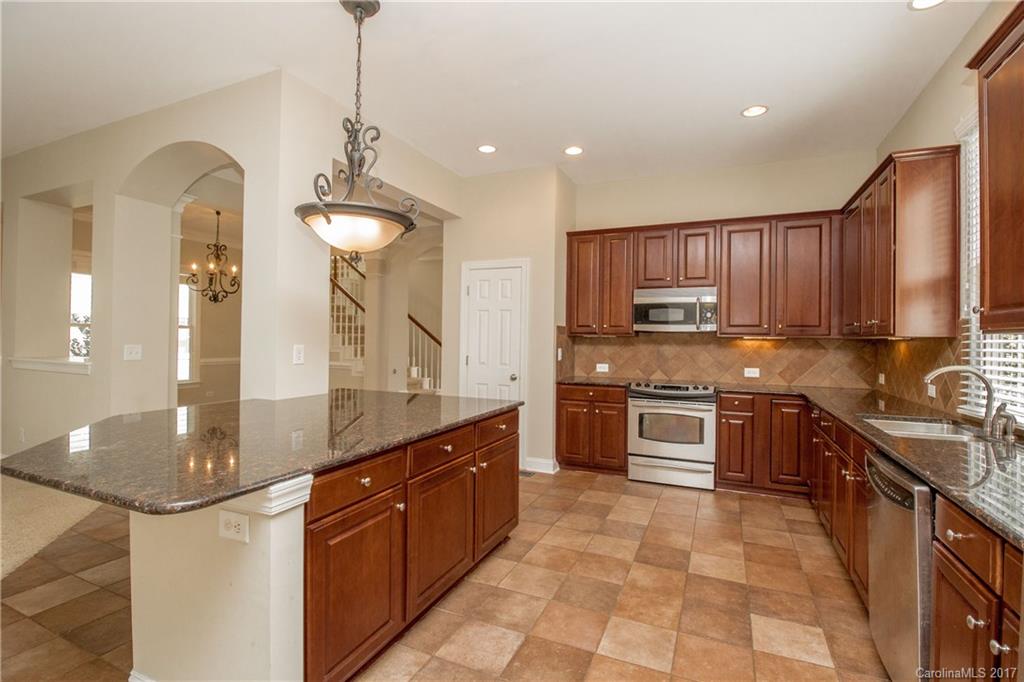 874 Promenade Walk, Unit 680 Fort Mill, SC 29708 - Photo 8 of 21 a kitchen with stainless steel appliances granite countertop a sink a stove and a refrigerator