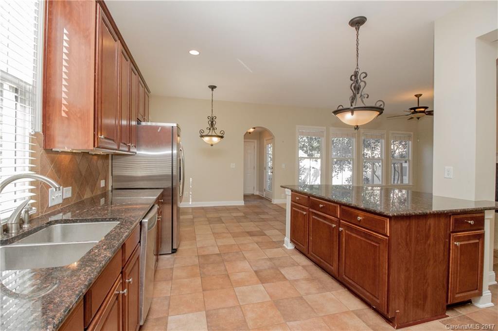 874 Promenade Walk, Unit 680 Fort Mill, SC 29708 - Photo 9 of 21 a kitchen with stainless steel appliances granite countertop a sink and a stove