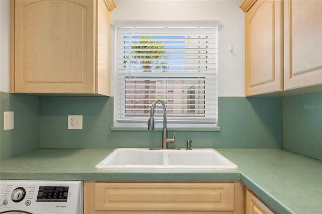 a kitchen with a cabinets and a window