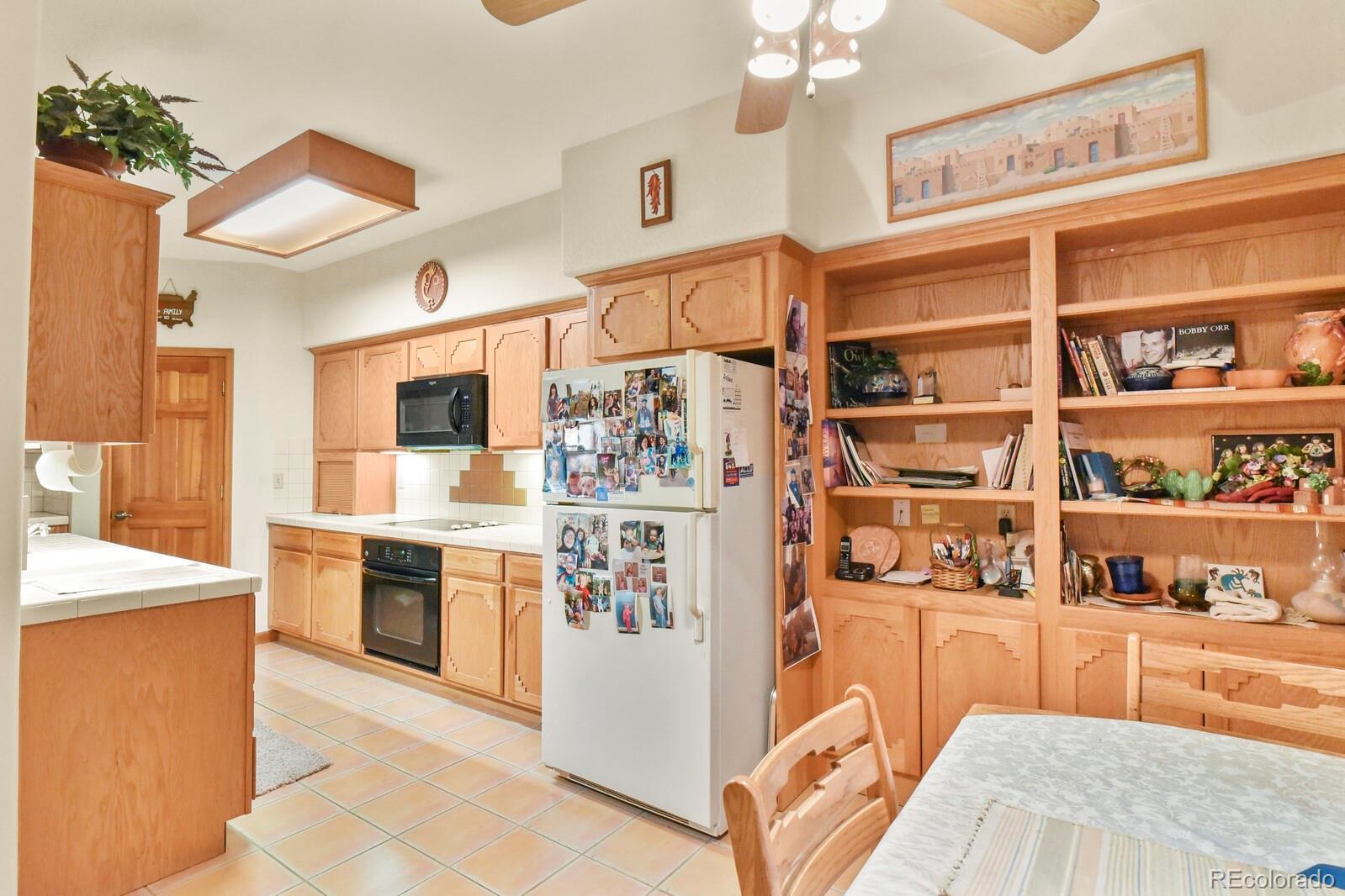 19085 Merry Men Circle Monument, CO 80132 - Photo 13 of 50 a kitchen with stainless steel appliances granite countertop a refrigerator and a stove top oven