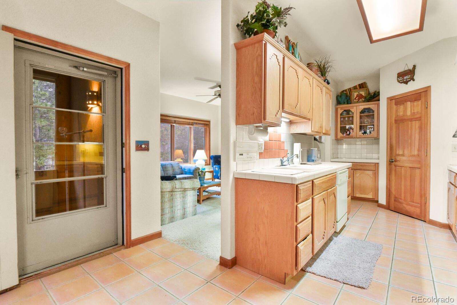 19085 Merry Men Circle Monument, CO 80132 - Photo 14 of 50 a kitchen with a refrigerator and a sink