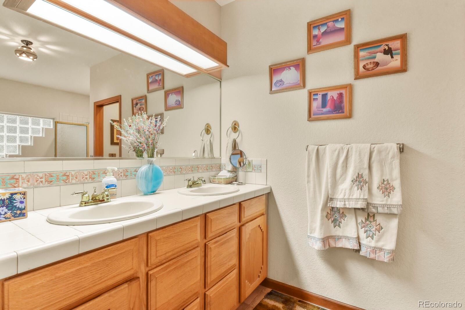19085 Merry Men Circle Monument, CO 80132 - Photo 20 of 50 a bathroom with a sink and a mirror