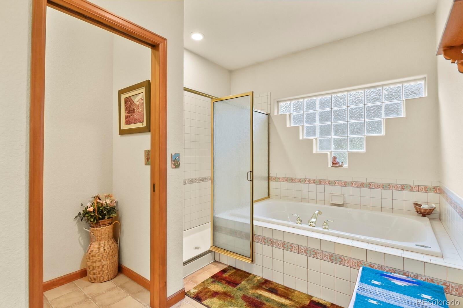 19085 Merry Men Circle Monument, CO 80132 - Photo 21 of 50 a bathroom with a bathtub and a shower