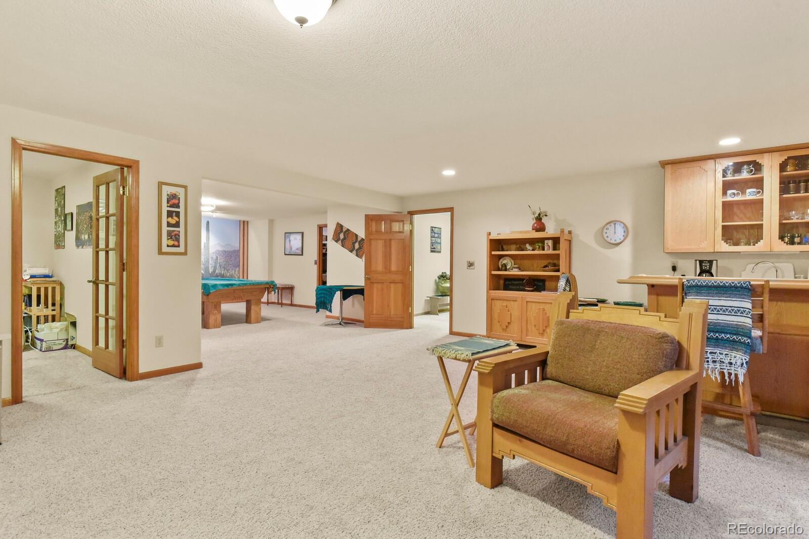 19085 Merry Men Circle Monument, CO 80132 - Photo 27 of 50 a living room with furniture and a flat screen tv