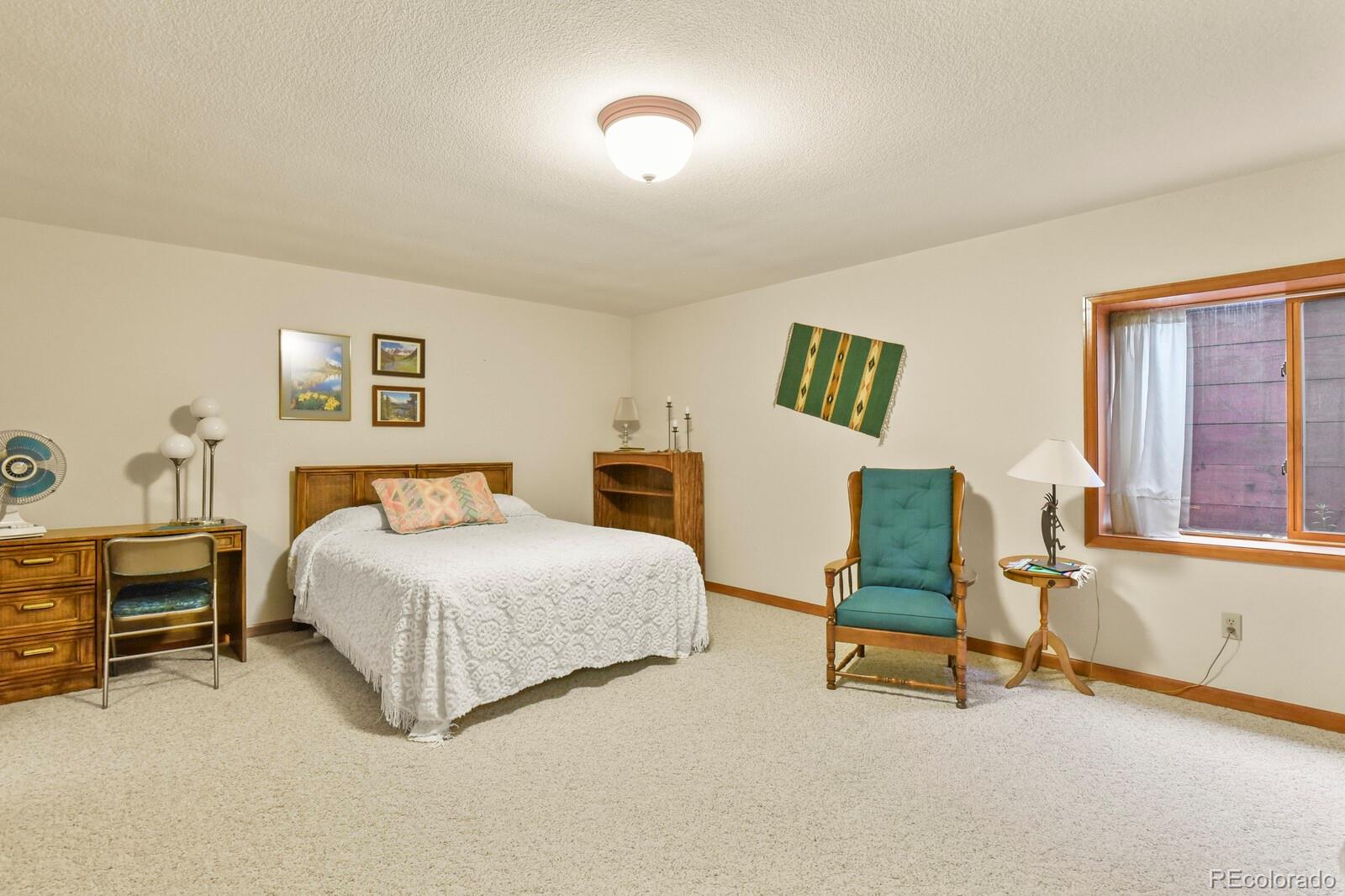 19085 Merry Men Circle Monument, CO 80132 - Photo 34 of 50 a bedroom with a bed chair and window