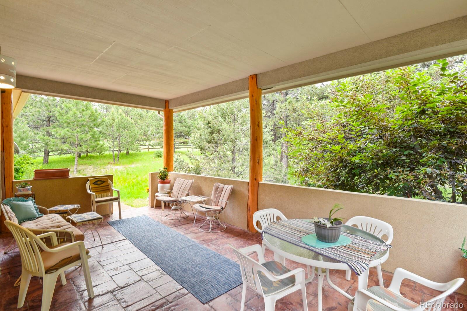 19085 Merry Men Circle Monument, CO 80132 - Photo 35 of 50 a living room with patio furniture and a large window