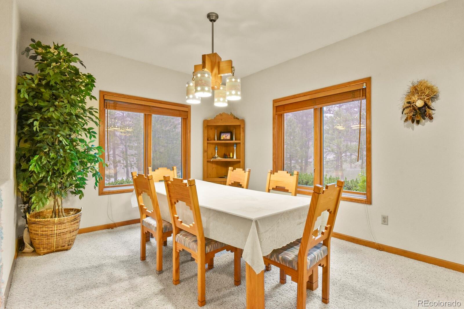 19085 Merry Men Circle Monument, CO 80132 - Photo 4 of 50 a view of a dining room with furniture window and outside view