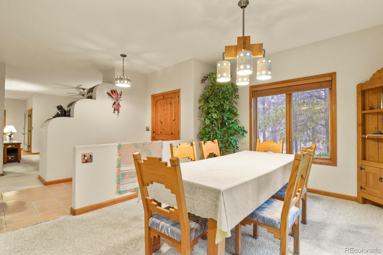 19085 Merry Men Circle Monument, CO 80132 - Photo 5 of 50 a view of a dining room with furniture window and outside view