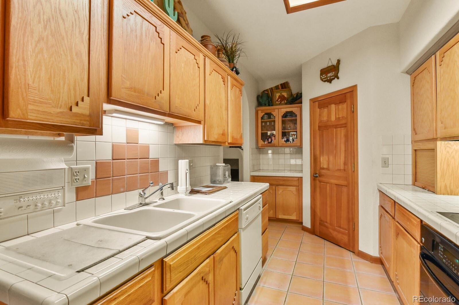19085 Merry Men Circle Monument, CO 80132 - Photo 10 of 50 a kitchen with a sink stove and refrigerator