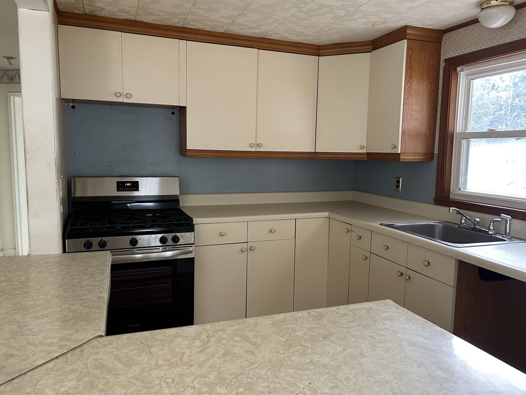 7 Ox Road Billerica, MA 01821 - Photo 4 of 7 a kitchen with white cabinets a sink and a stove