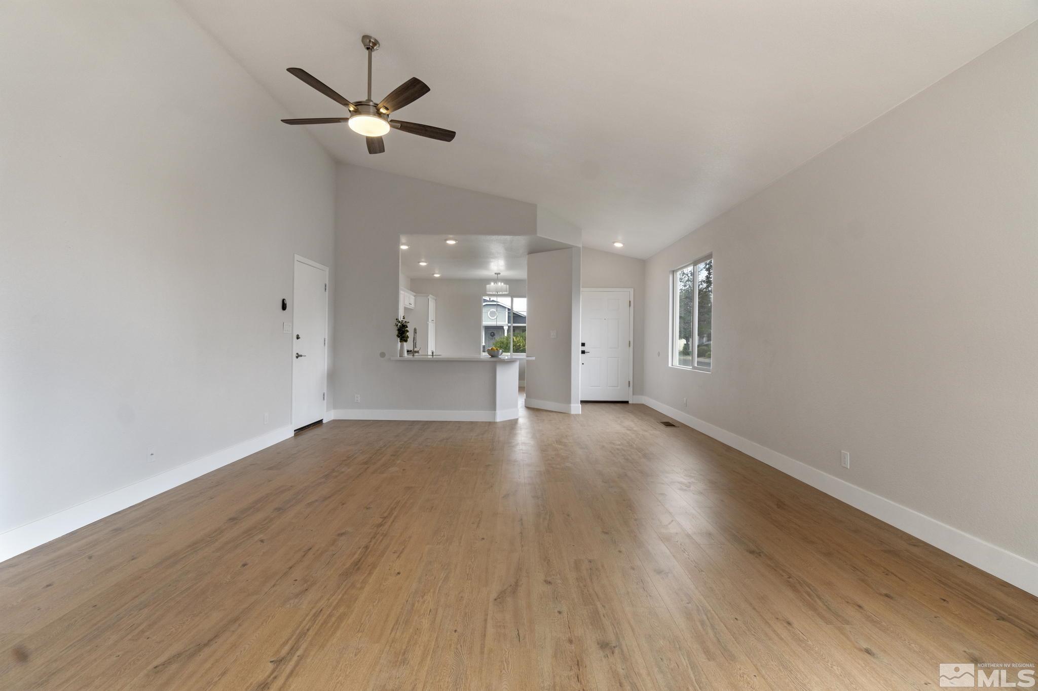 10000 Eagles Landing Court Reno, NV 89521 - Photo 8 of 37 a view of an empty room with a ceiling fan and wooden floor